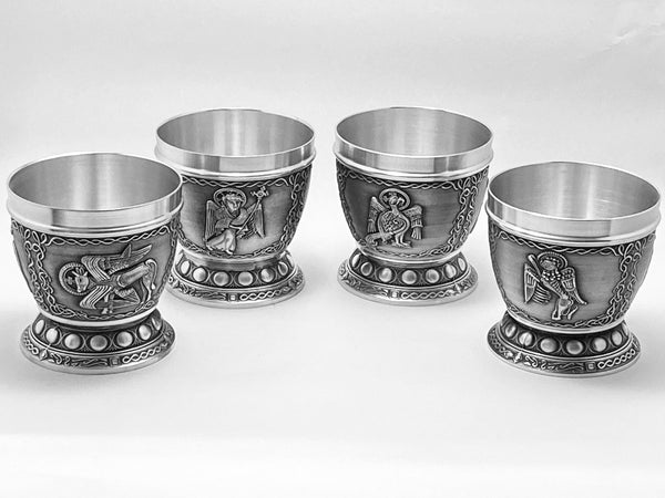 4 WHISKEY TUMBLERS WITH BOOK OF KELLS DESIGNS ARE OF THE 4 EVANGELISTS FORM THE BOOK OF KELLS VERSION OF THE FOUR GOSPELS. LUKE THE OX, MATHEW THE MAN, JOHN THE EAGLE AND MARK THE LION. THE TUMBLERS ARE SURROUNDED BY CELTIC DESIGN AND FINISH ON BOTH THE BODY OF THE CUP AND THE STEM. THE INSIDE OF THE CUPS ARE HANDTURNED TO A HIGH SILVER POLIHED FINISH AND THE BASES ARE ALSO POLISHED AND HAVE THE COMPANY TOUCH MARK. PEWTER SILVER FINISHED POLISH.