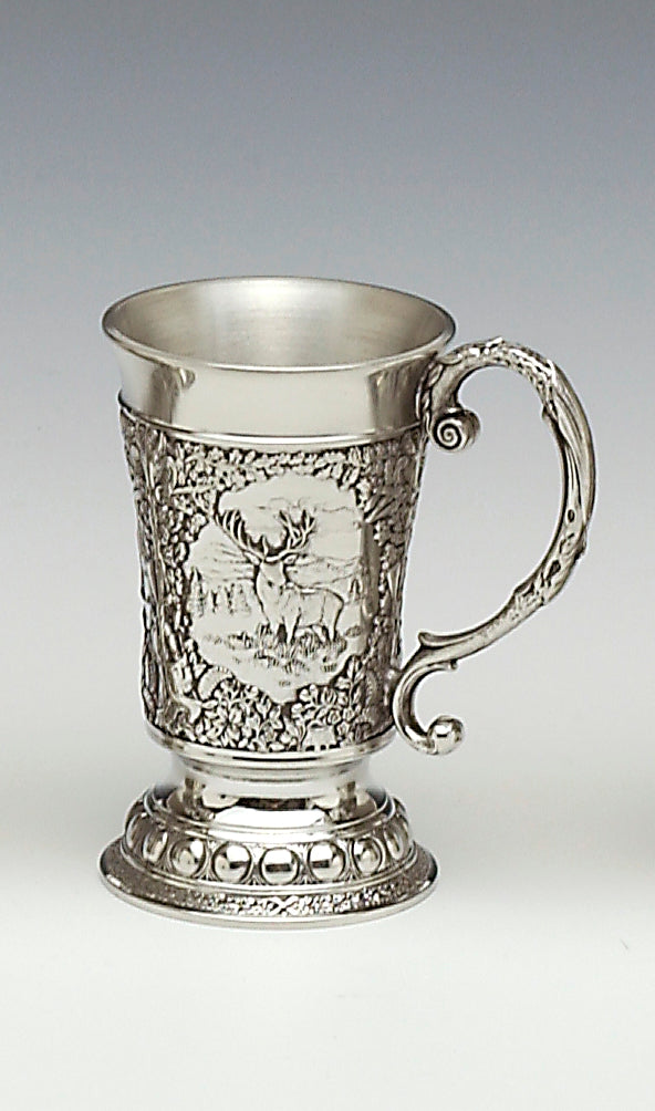 THIS MEASURE WITH ATTACHED DECORATED HANDLE HAS STAG, DEAR AND WILD TURKEY IN WOODLAND SETTINGS. THE MEASURE IS 2"TALL AND HOLDS 1 FLUID OZ. THE BASE IS DECORATED WITH BEADING AND GENERIC DECORATION. HANDMADE IN IRELAND BY MULLINGAR PEWTER.