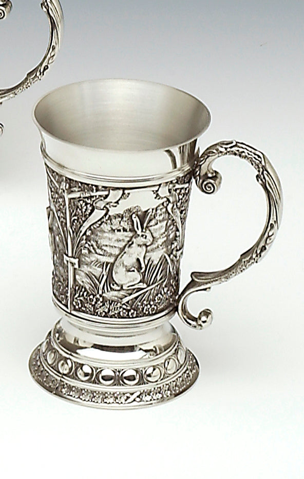 Handcrafted Pewter tankard embossed with woodland scenes this picture highlights the Irish Hare. The tankard stands 5 1/2" tall and holds 12 fluid ozs. Great for a cool beer. Handmade in Ireland by Mullingar Pewter