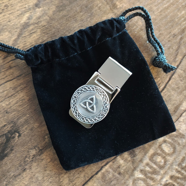 Money Clip by Mullingar Pewter embellished with a trinity knot and sitting on a black draw string bag