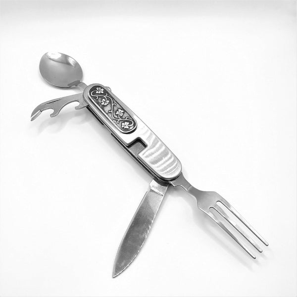 Camping utensil, camper cutlery which fold to fit in pocket. Silver in colour and  embellished with shamrocks